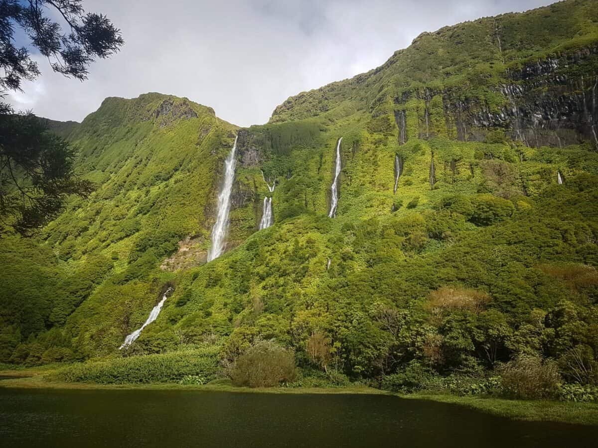 Waterfalls cascading down lush green cliffs on Flores in the Azores, Portugal