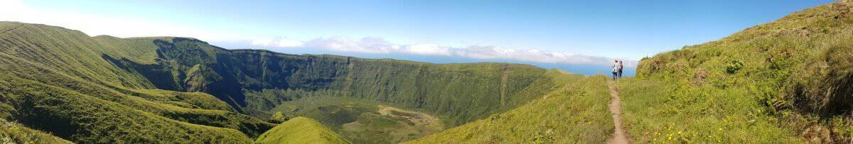 Wide view of hikers standing on rim of the caldeira on Faial in the Azores