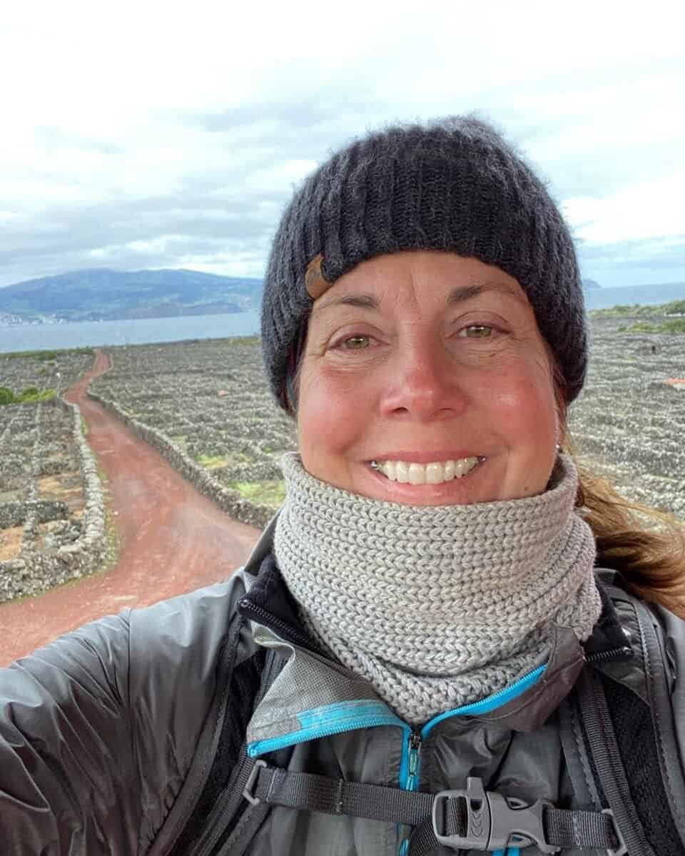 smiling traveler standing in a volcanic vineyard on Pico Island in the Azores, Portugal