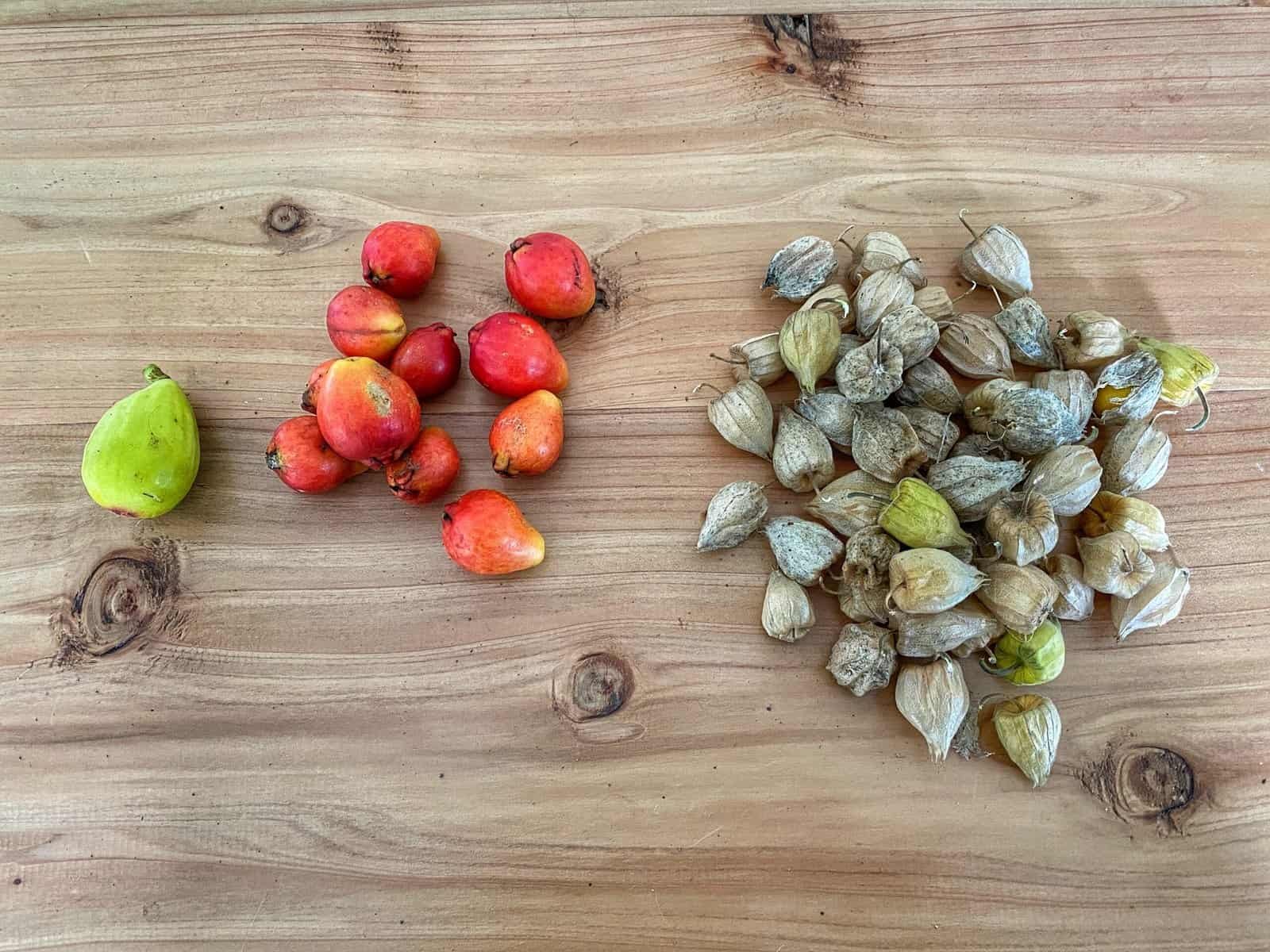 Fresh fruits of the Azores displayed on a wooden surface.