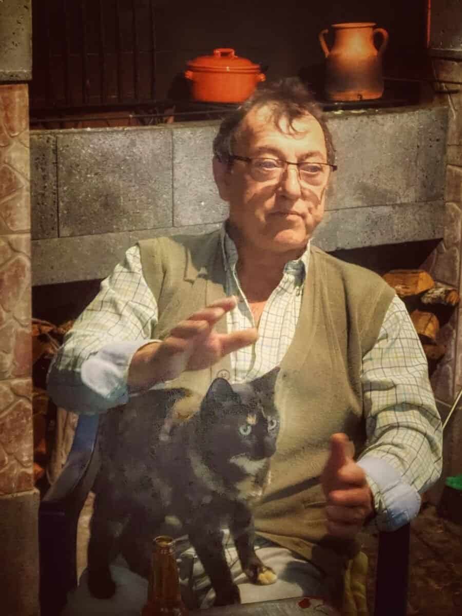 Man with cat in front of fireplace with traditional pottery in the Azores