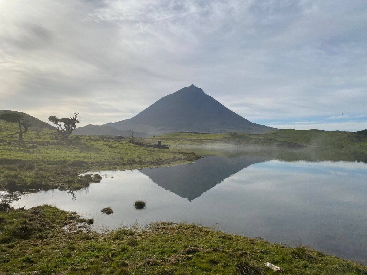 Lagoa do Capitão reflecting massive Pico mountain in the Azores